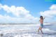 A woman in a bikini standing in the ocean.