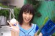 A woman in a blue and white uniform holding a baseball.