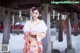 A woman in a kimono standing in the snow.