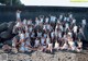 A group of women in white bathing suits posing for a picture.